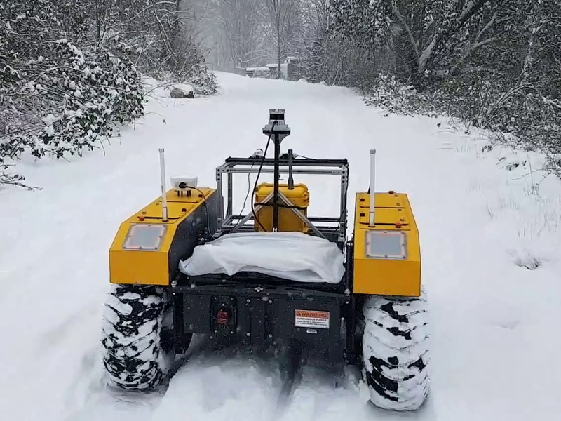 Robot Learning lab cover photo of robotic warthog/all terrain vehicle driving in the snow