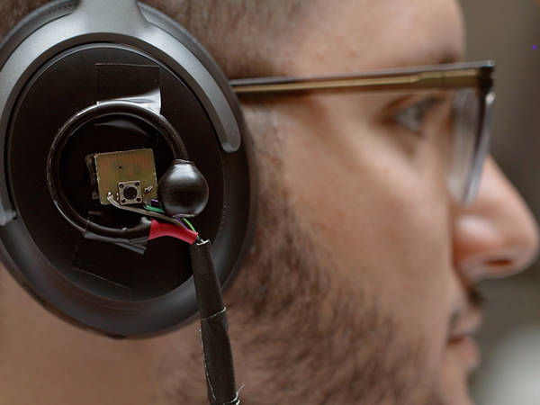 Closeup of AI-augmented headphone on person's ear