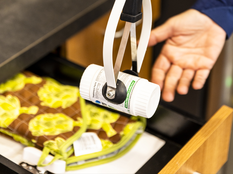 Human-Centered Robotics Lab photo of a robot assisting with picking up a bottle