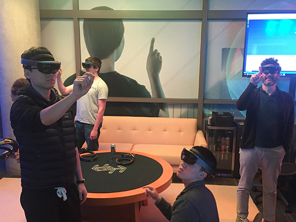 People wearing AR-VR headsets pointing into the air