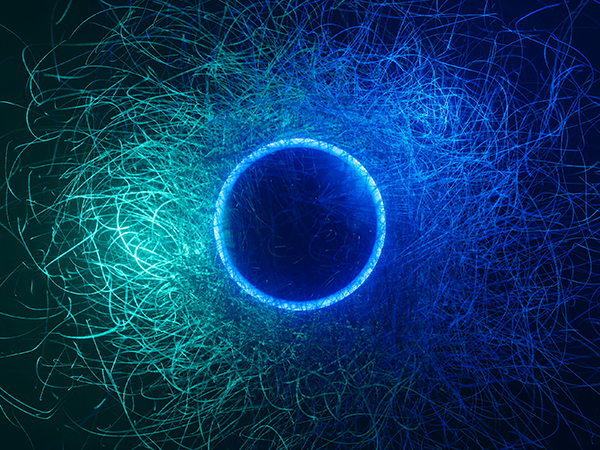 Abstract graphic of a blue-tinged circle surrounded by trails of light in varying shades of green and blue against a black background