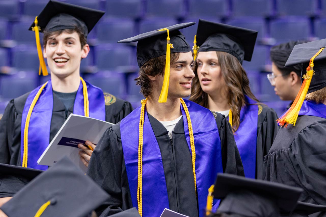 Allen School students wearing their cap and gown on graduation day