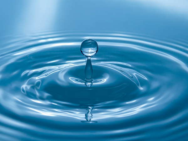 Closeup of a droplet of water causing ripples