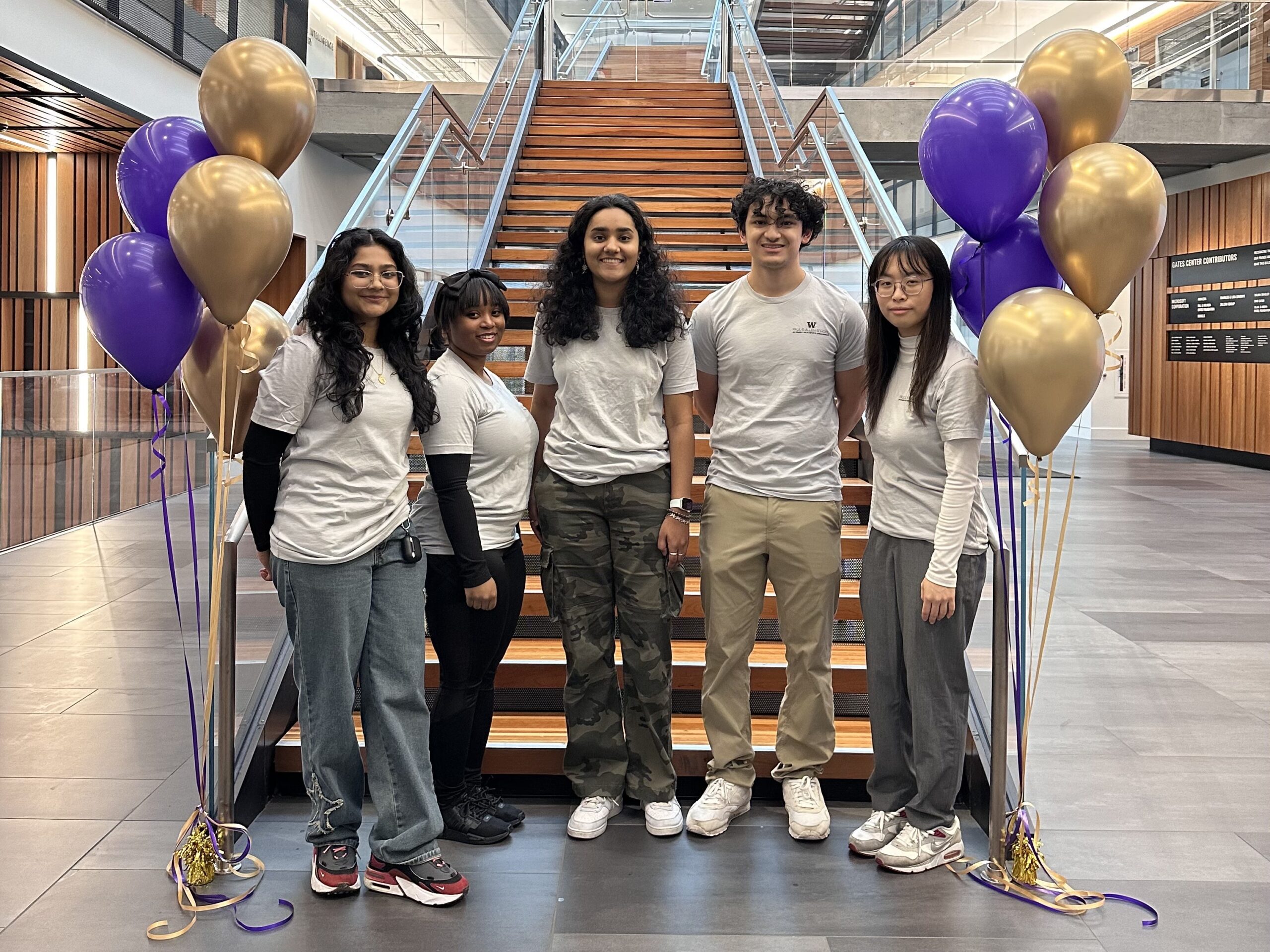 Student Recruitment Representatives team photo taken in the Gates Center atrium amongst purple and gold ballons.