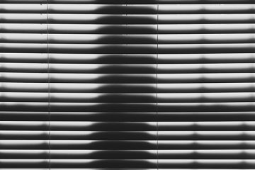 Black and white parallel lines created by window blinds and shadow