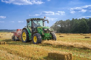 A tractor in a sunlit field